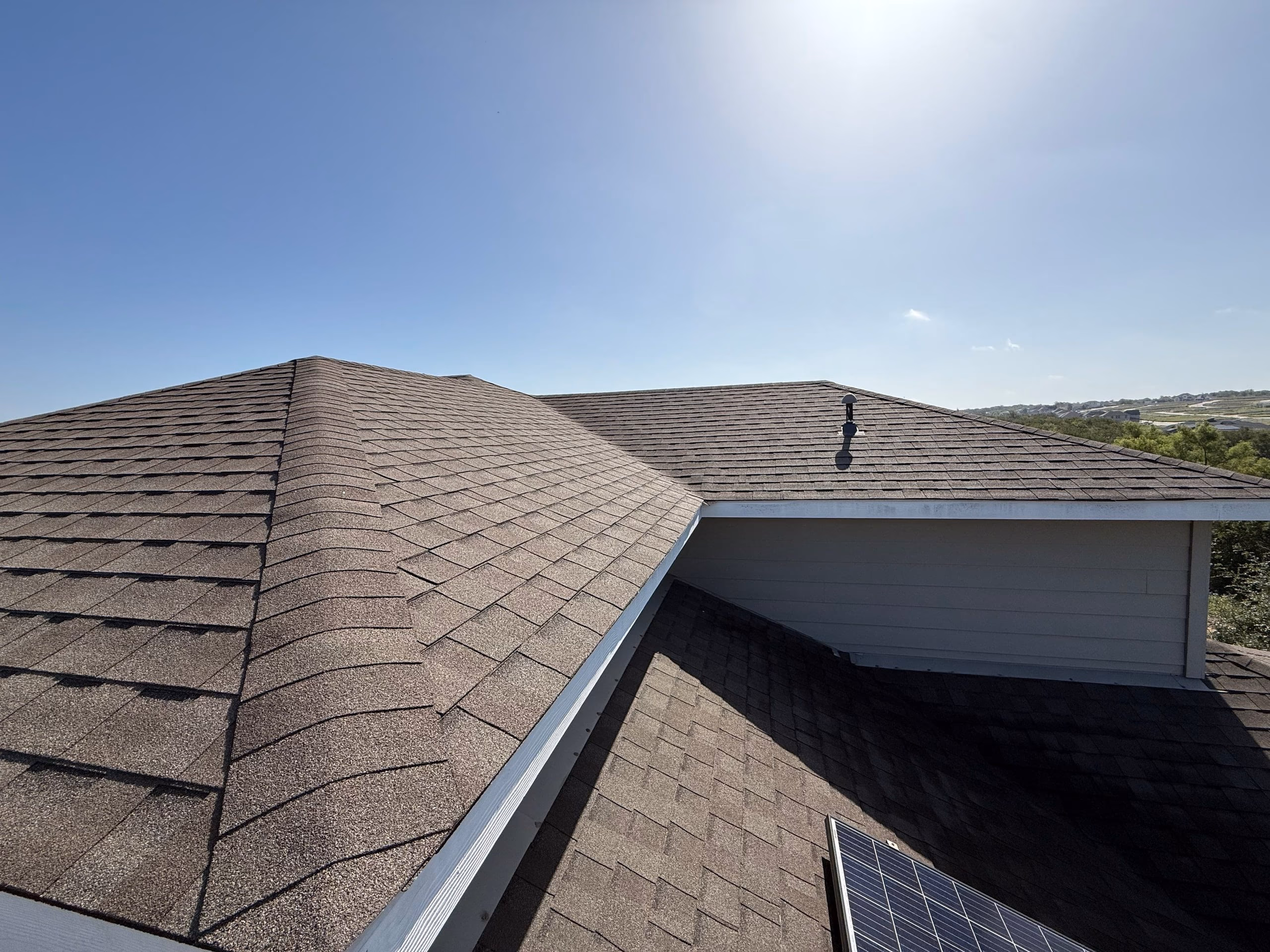 Rooftop view of a brown architectural shingle roof in good condition after a free roof inspection in Austin, TX