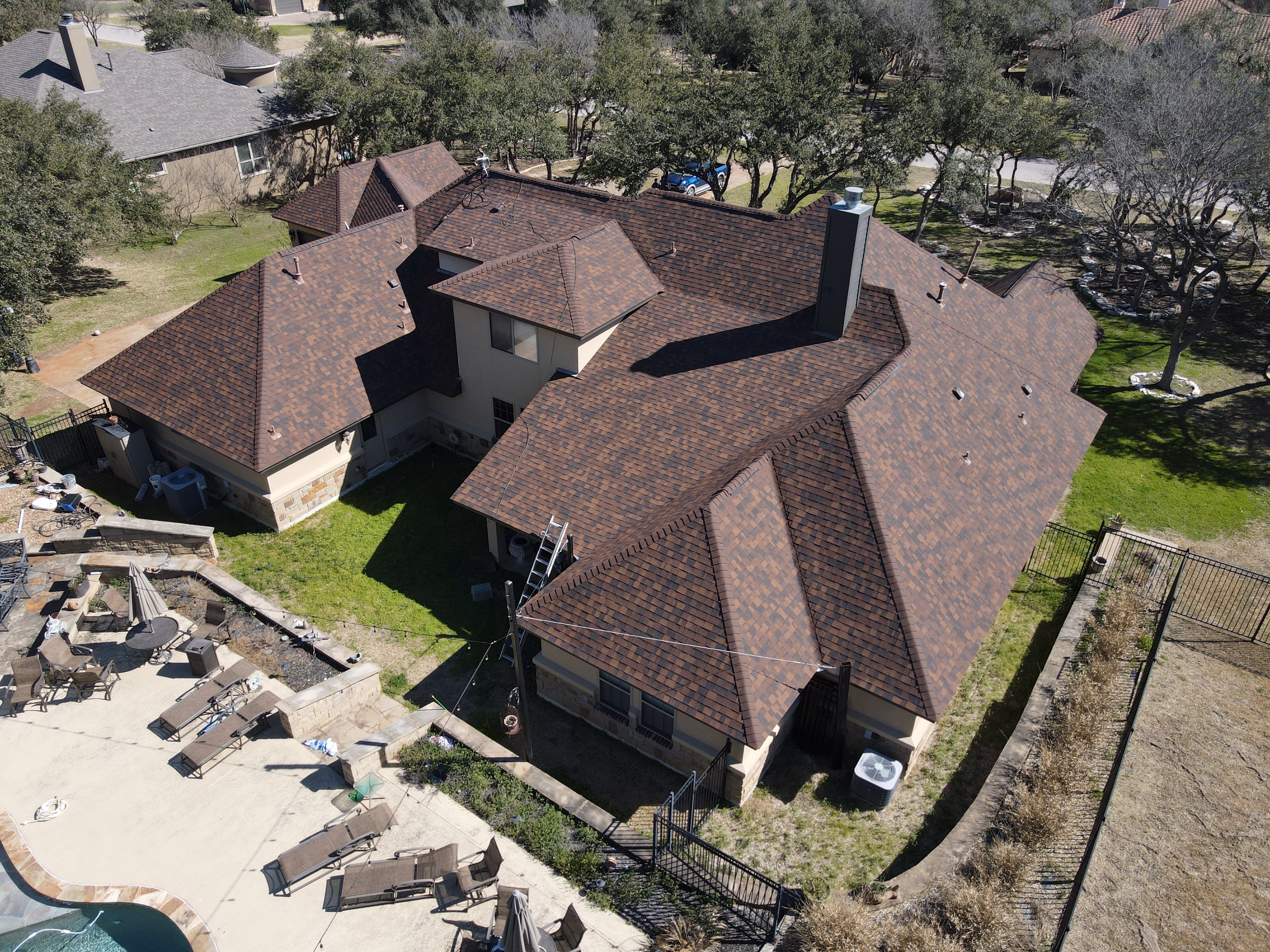 Drone view of a completed architectural shingle roof replacement in Austin TX