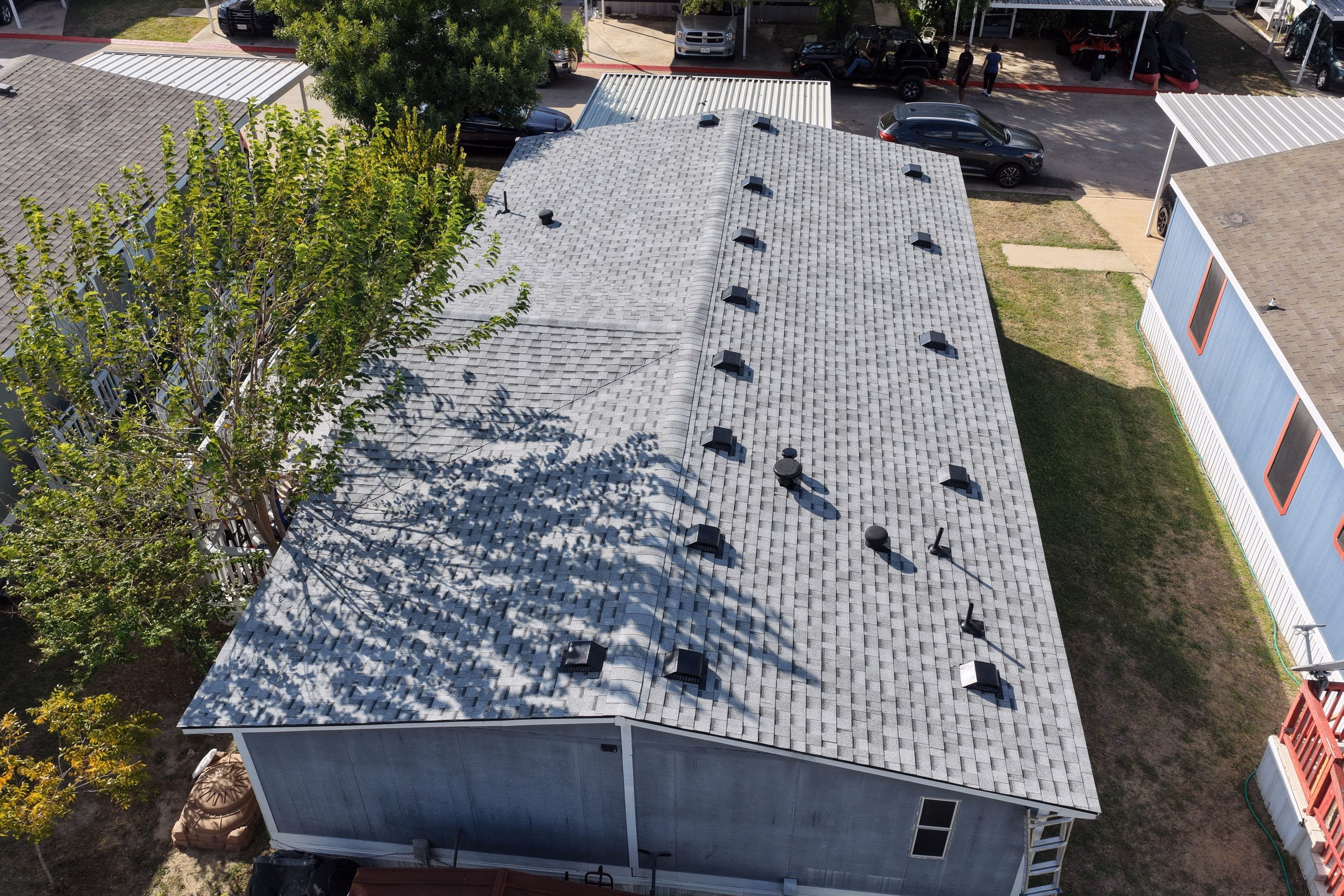 Aerial view of a completed shingle roof replacement on a home in Austin, TX