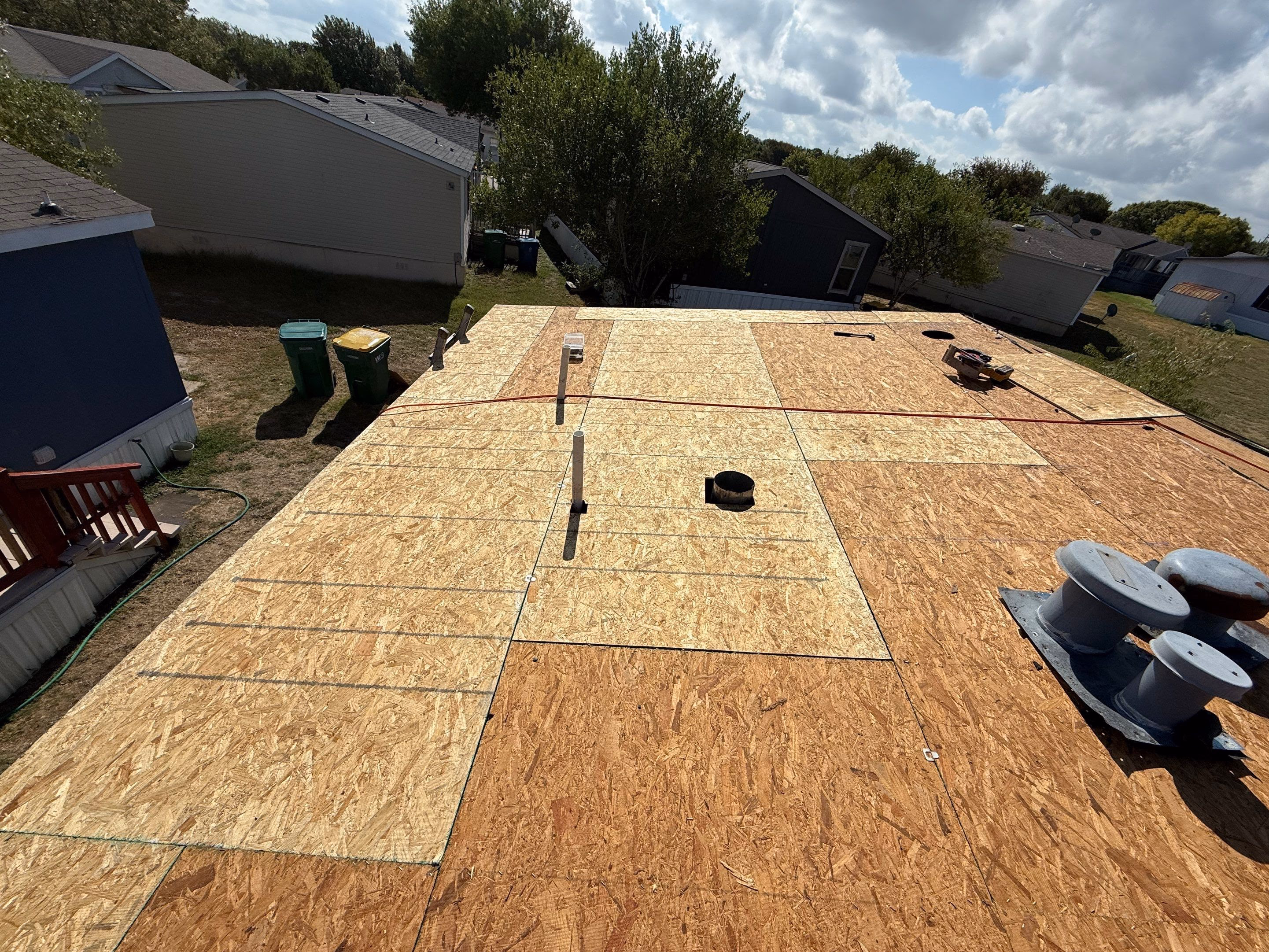 Aerial view of a fully installed new plywood roof deck ready for underlayment during a roof replacement in Austin, TX
