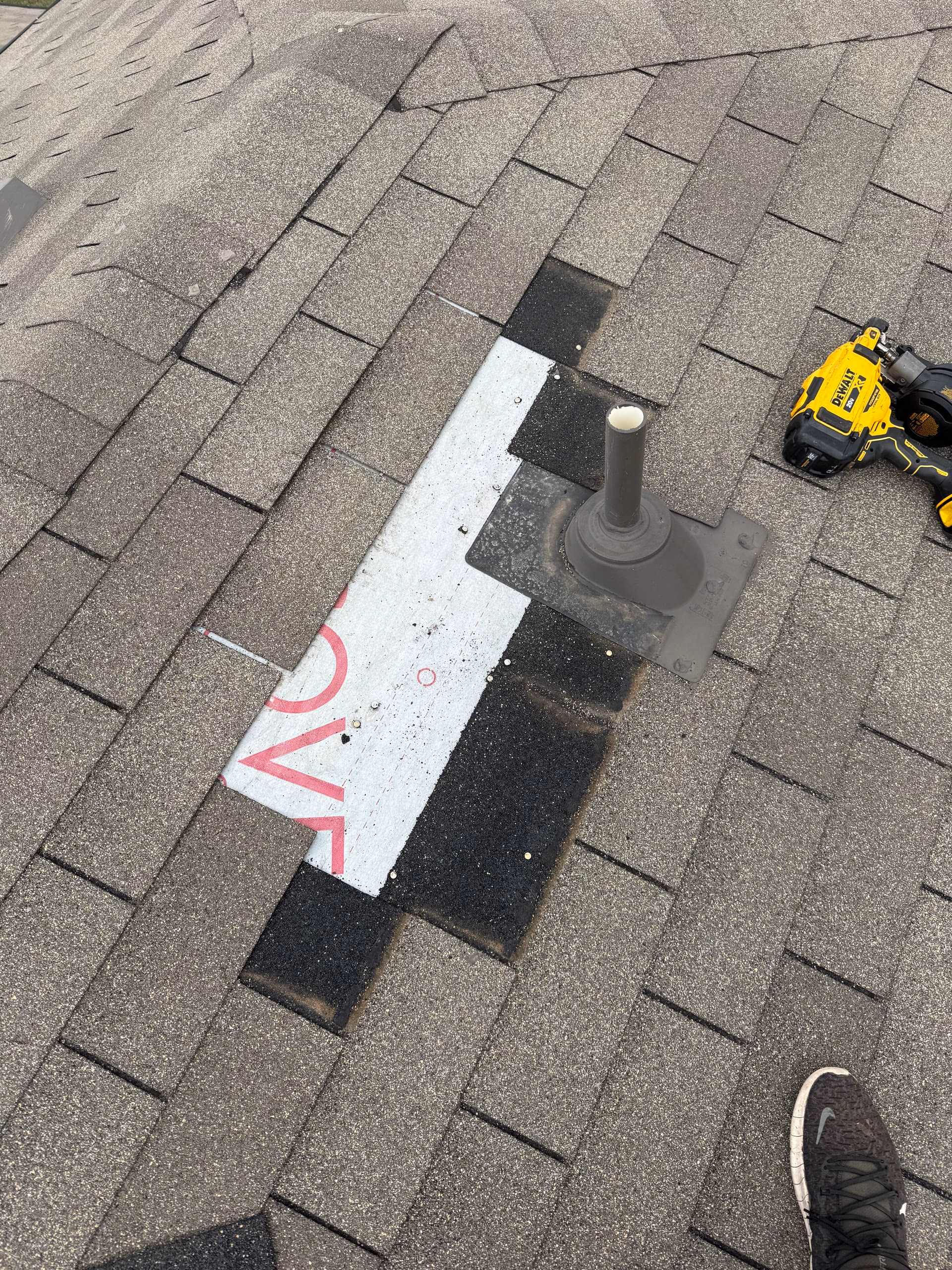 New pipe boot flashing installed around a plumbing vent pipe on a gray shingle roof in Austin, TX