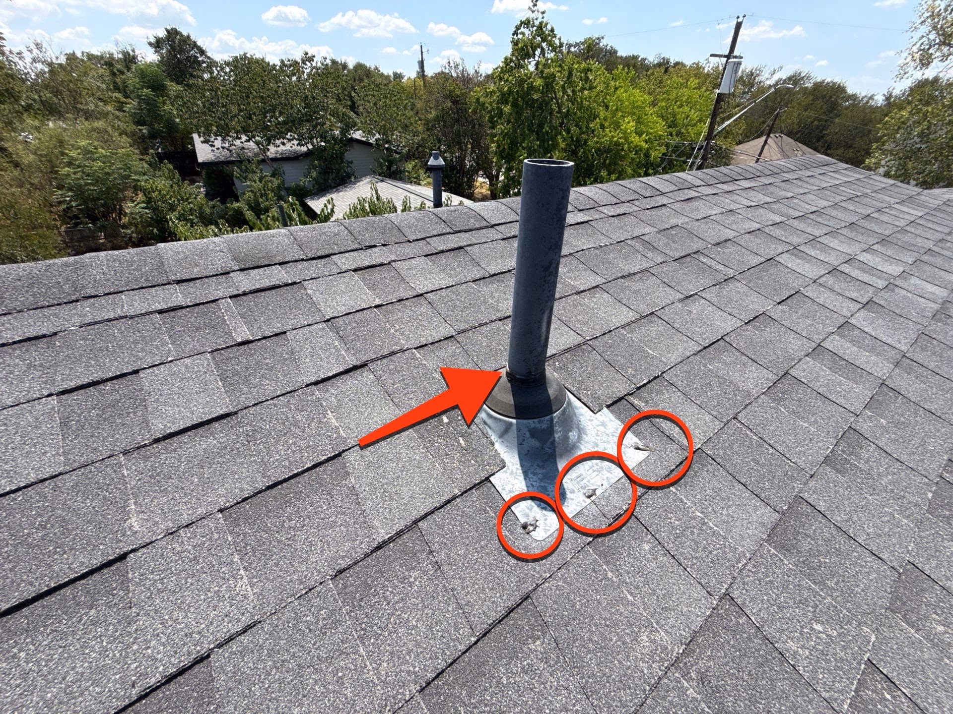 Pipe jack vent with failed sealant and exposed roofing nails circled on a Pflugerville, TX roof