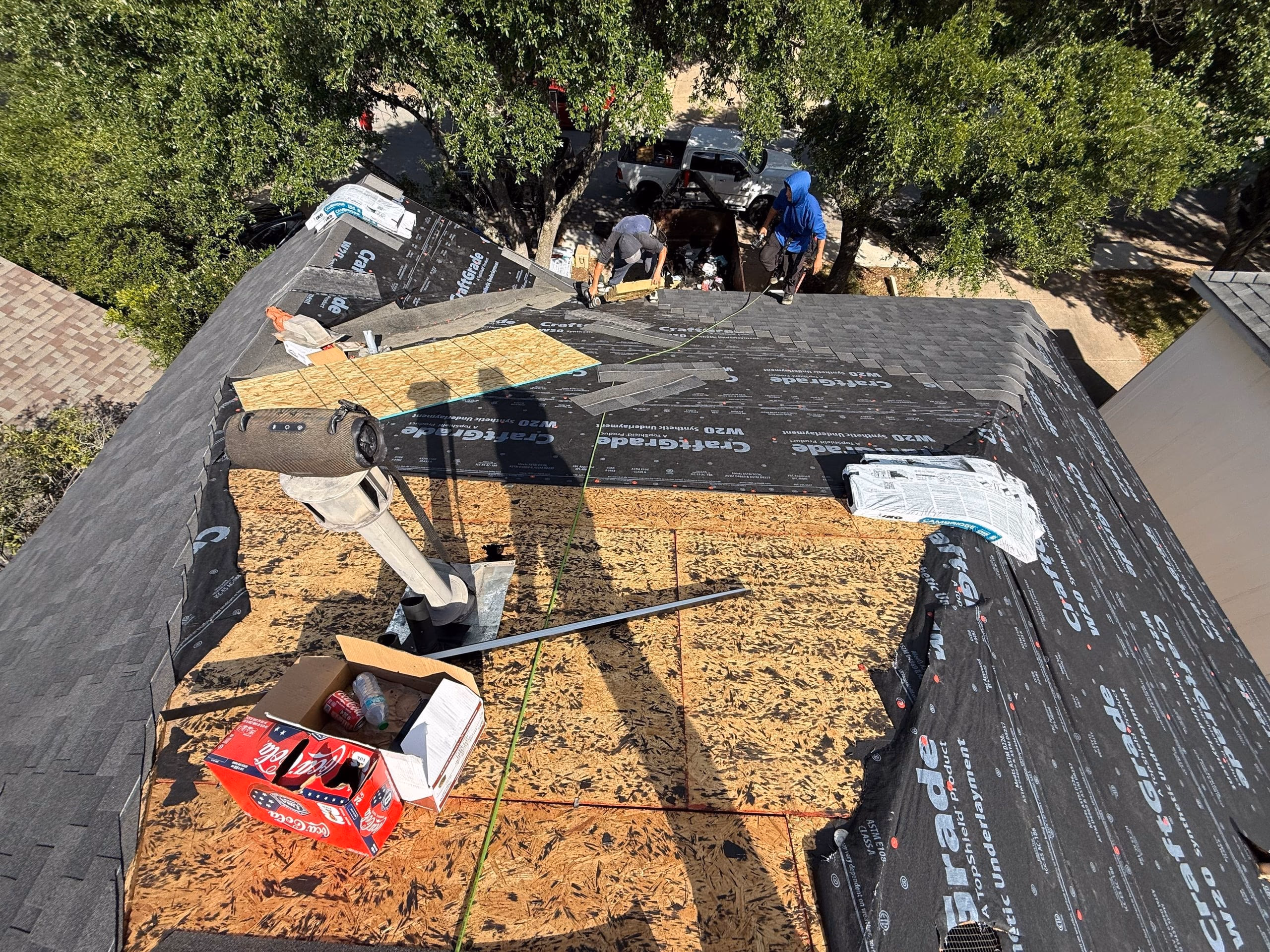 Bare roof decking and synthetic underlayment mid install during a roof replacement in Austin, TX