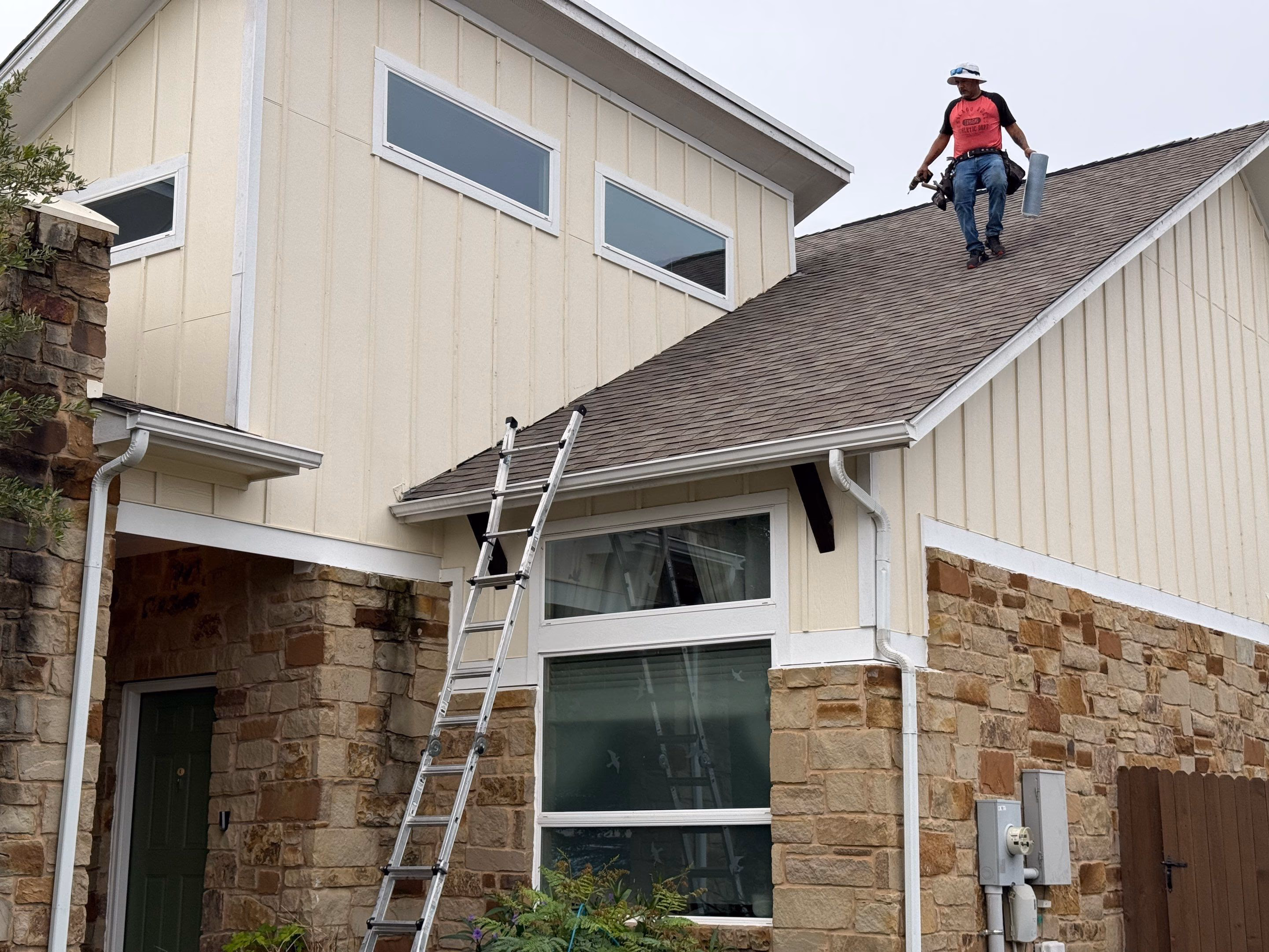 Austin Roofing Company crew member on an asphalt shingle roof during a repair in Austin, TX