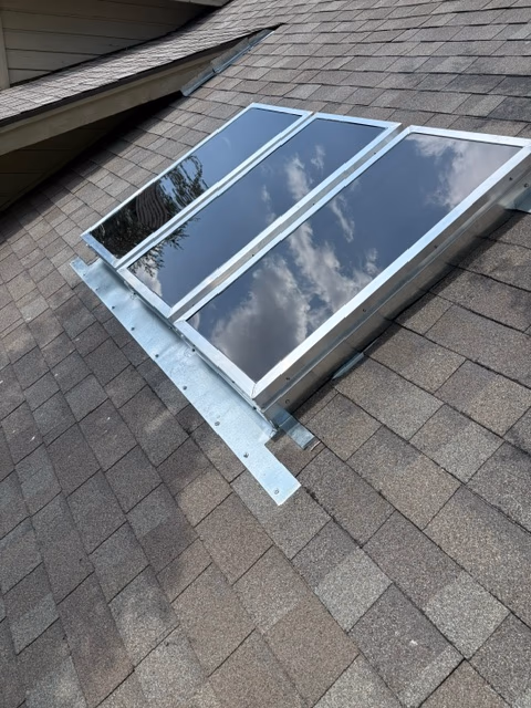 After skylight repair in Austin, TX: completed skylight with new aluminum flashing and sealed panes by Austin Roofing Company