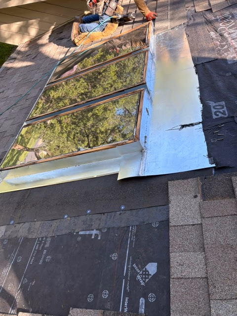 During skylight repair in Austin, TX: curb stripped and rebuilt with a new metal flashing pan and peel-and-stick underlayment by Austin Roofing Company