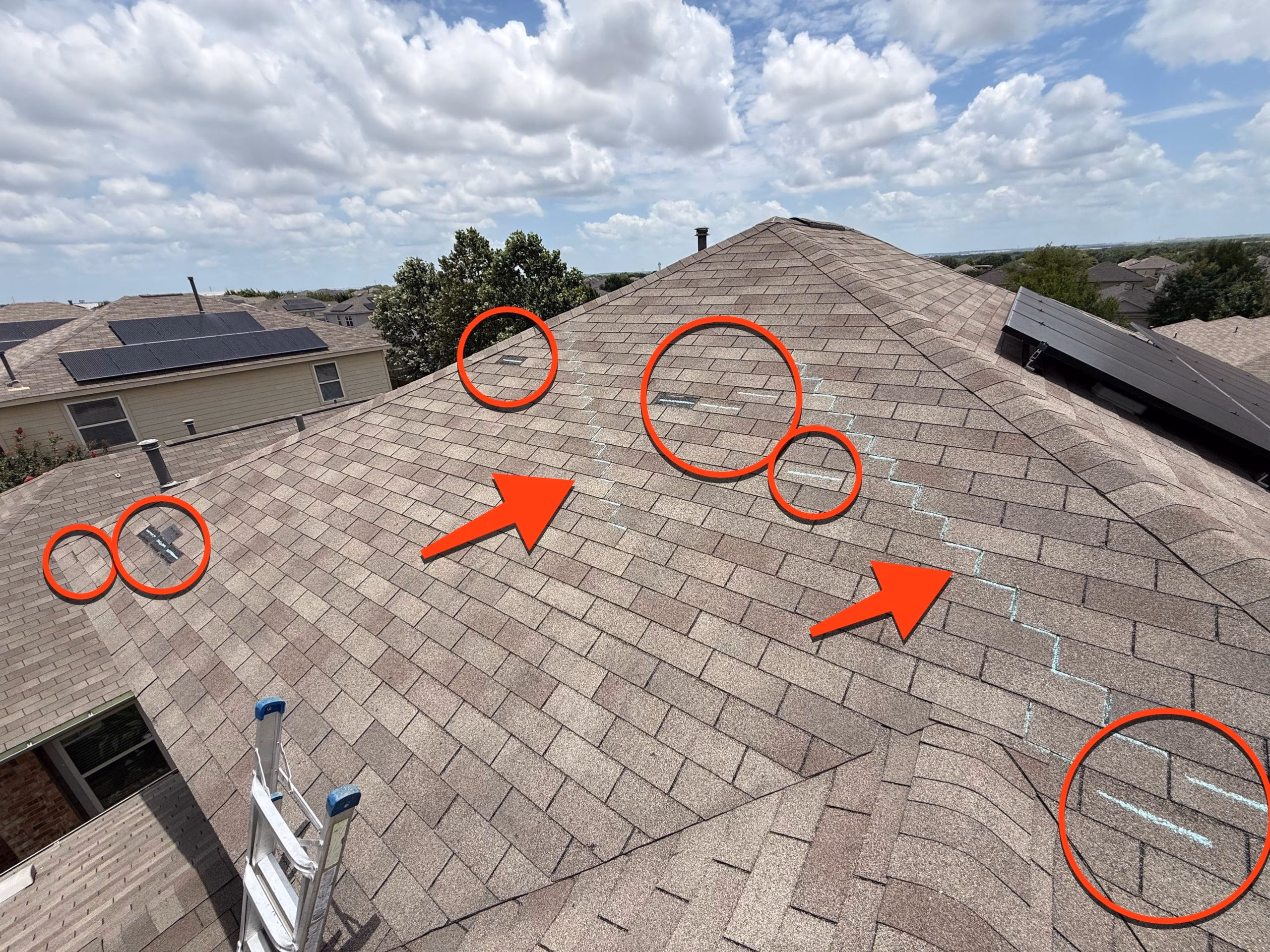 Roof inspection photo with red circles, arrows, and chalk lines marking storm damaged shingles on a tan roof in Austin, TX